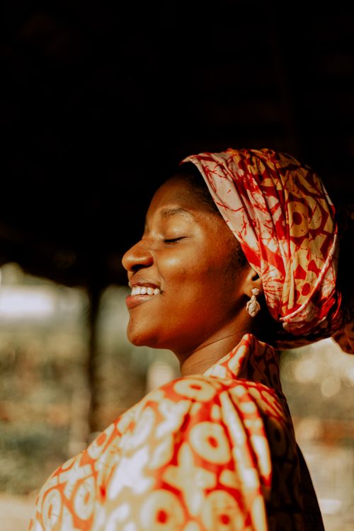Free A close-up portrait of a woman in colorful traditional attire, exuding joy and serenity Stock Photo