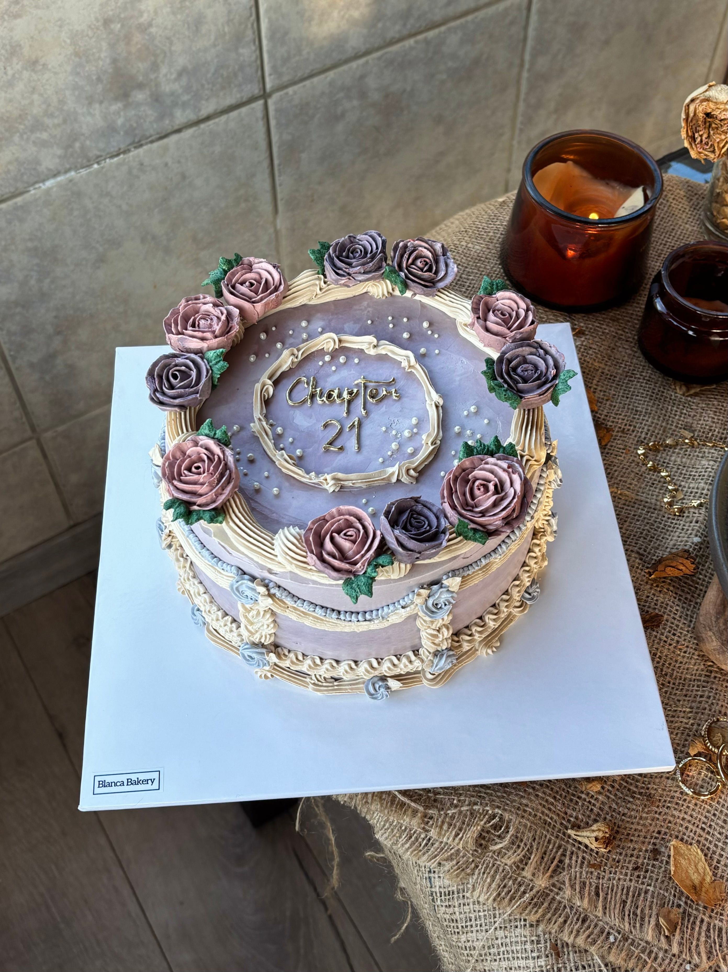 Elegant Floral Cake with 'Chapter 21' Topper Displayed · Free Stock Photo