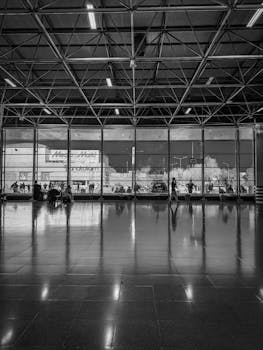 Spacious terminal interior in Bursa, Türkiye with people and geometric reflections.