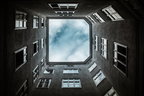 Low Angle Photo of Building Under Clouds