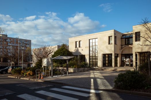 A modern public building in Compiègne, France, capturing a sunny day and clear skies.