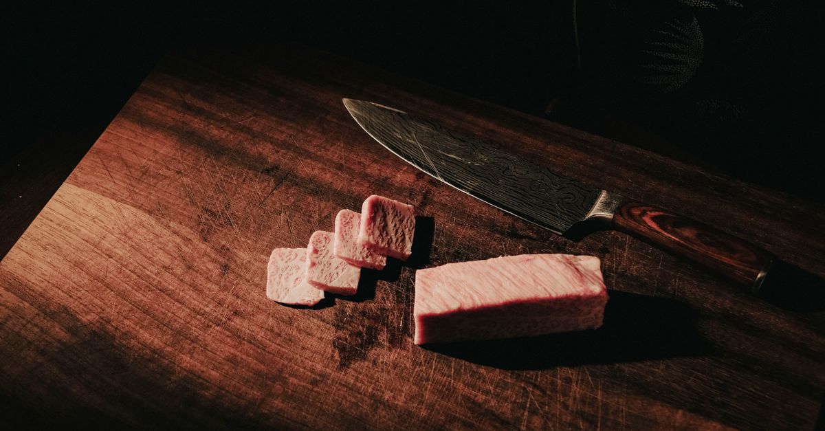 Chef slicing a plant-based steak that shows marbling and pink center