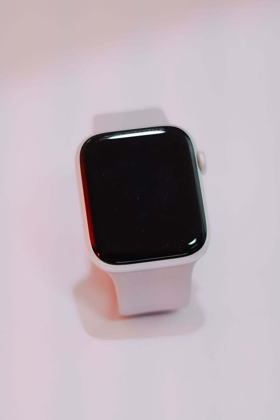 Smartwatch with a white band on a soft background