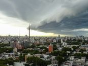 A striking storm cloud formation looming over Montevideo's urban landscape, creating a dramatic and intense atmosphere.