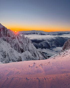 Breathtaking winter sunset over snowy Romanian mountain ridges with vibrant colors.