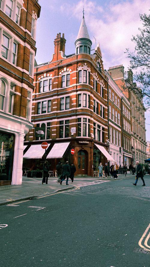 Free Charming view of historic red brick buildings in a busy London street. Stock Photo