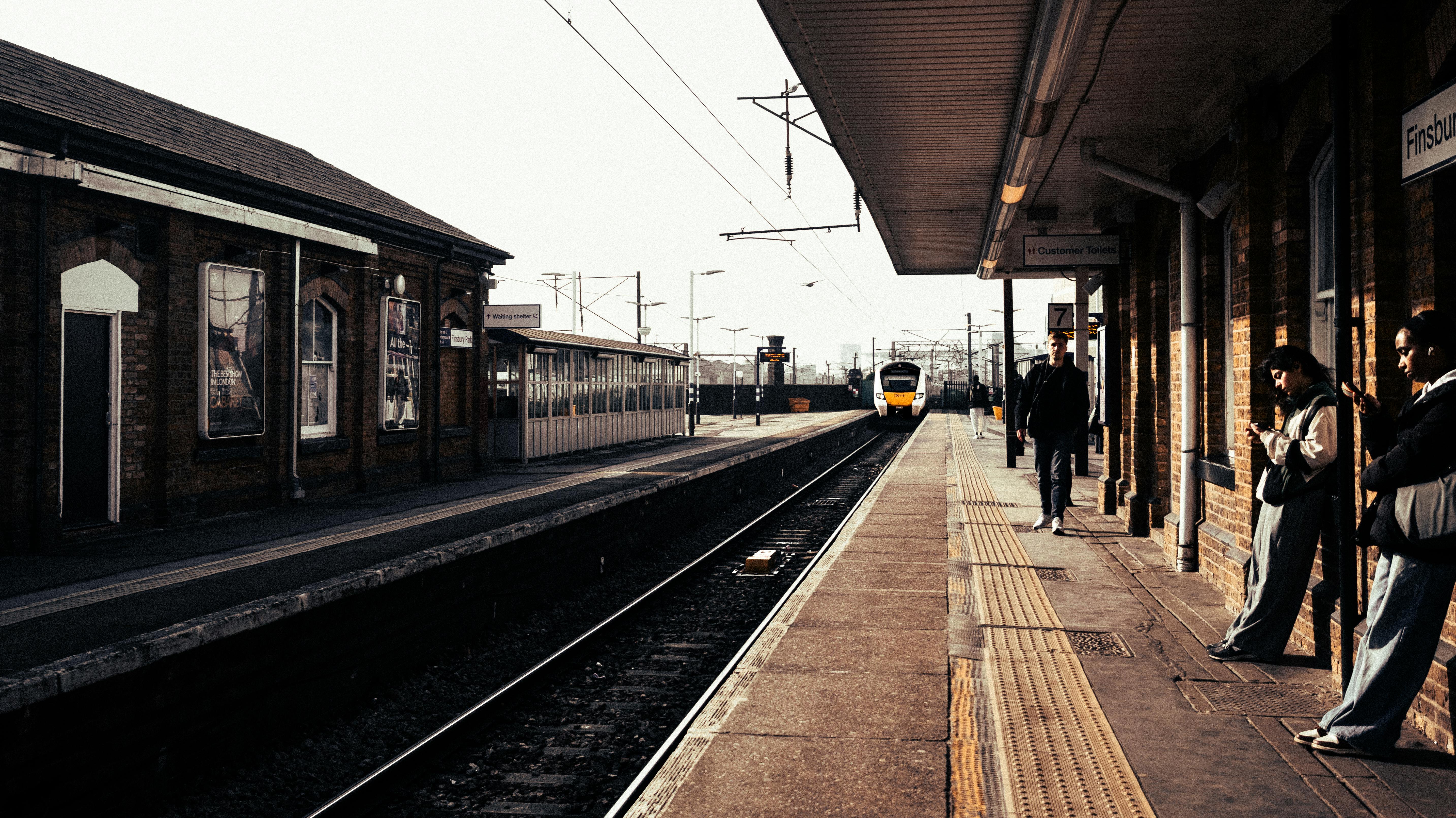 A British passenger train waiting at a station platform.
