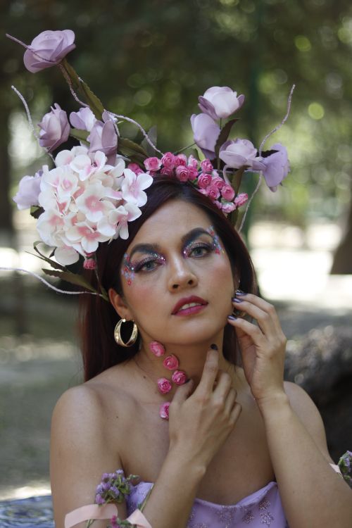 Free Portrait of a woman wearing a floral crown, embodying nature's beauty. Stock Photo