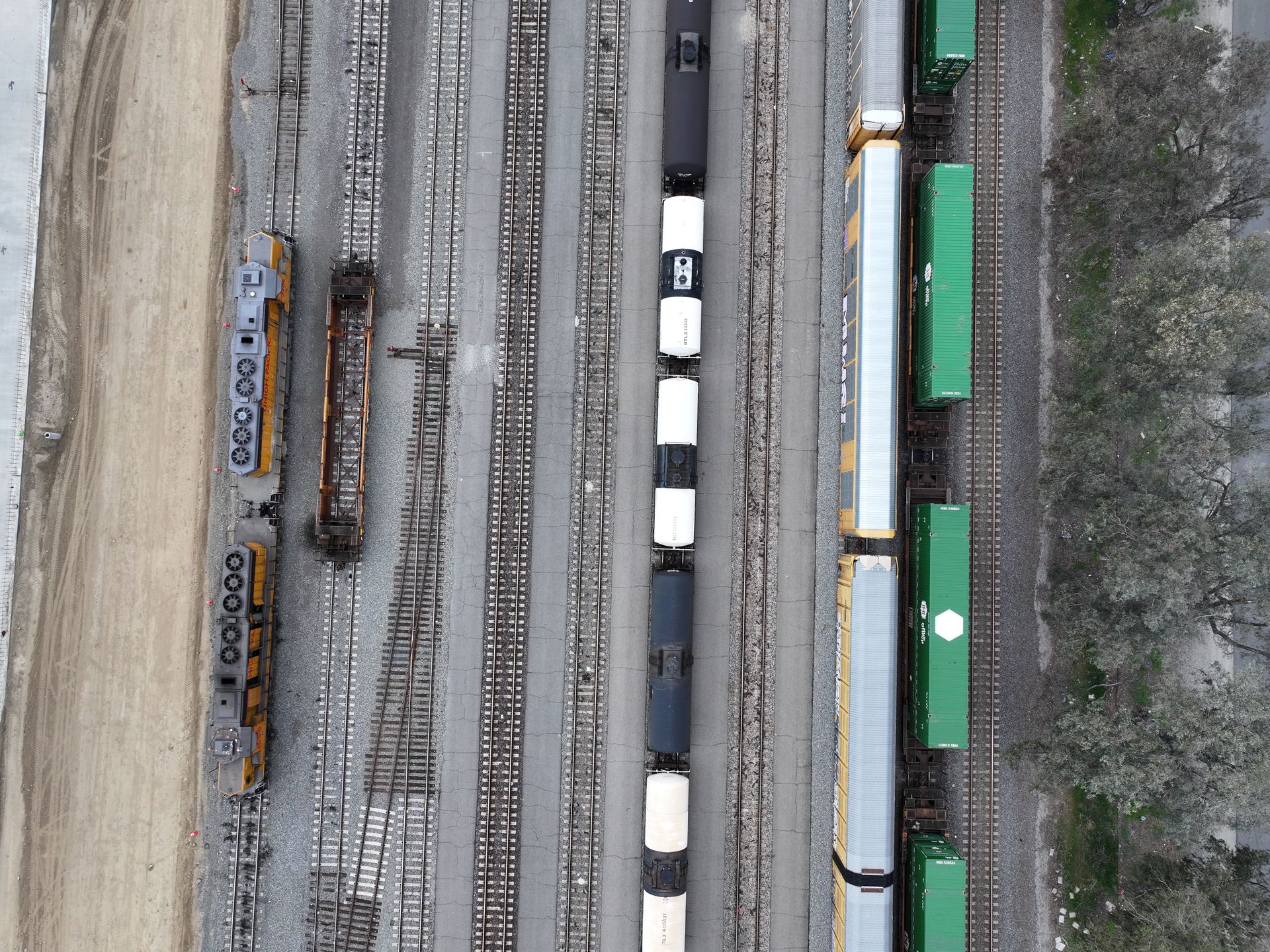 Aerial shot of a train yard in California showcasing multiple trains and tracks.