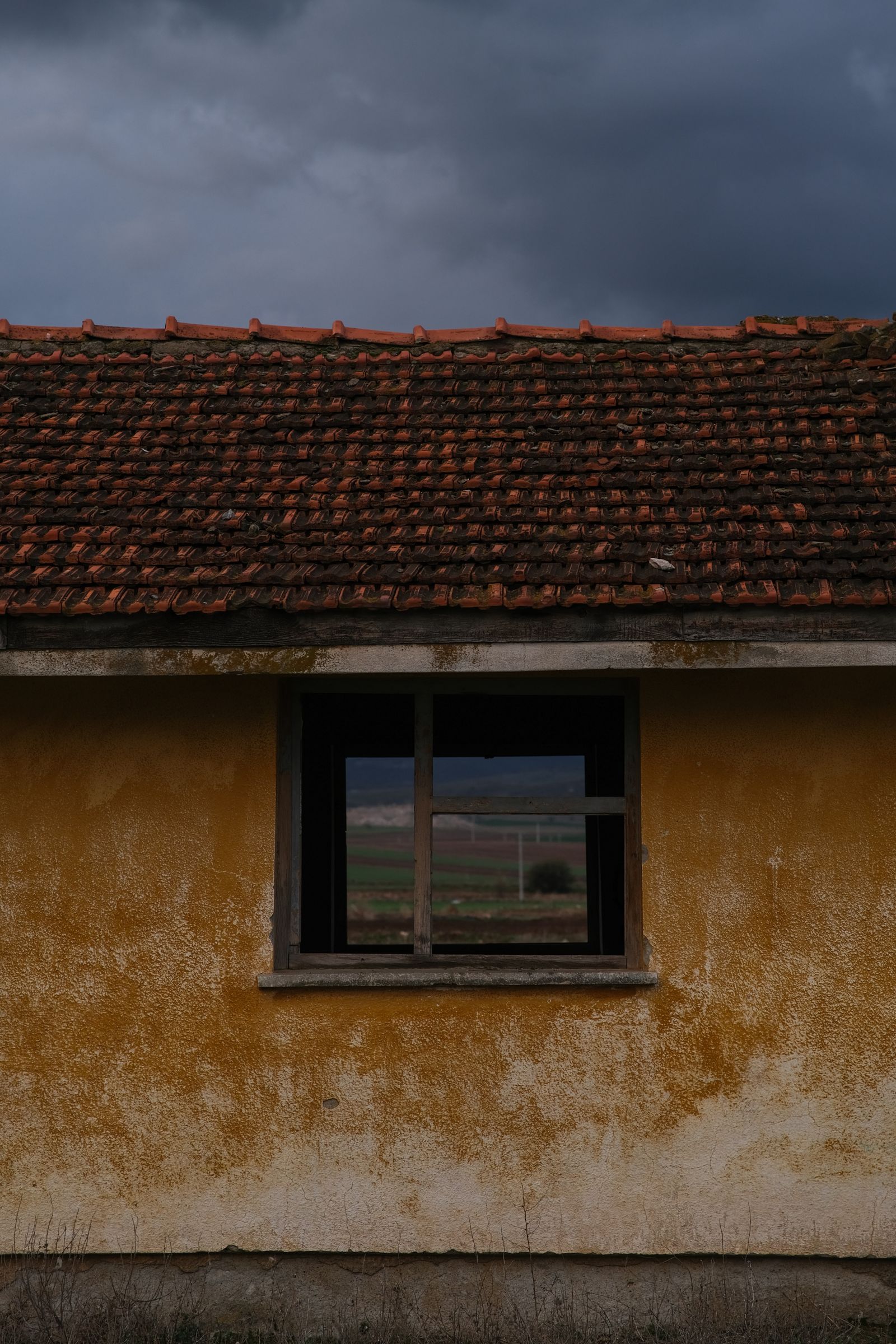 Ageing house with a weathered tiled roof