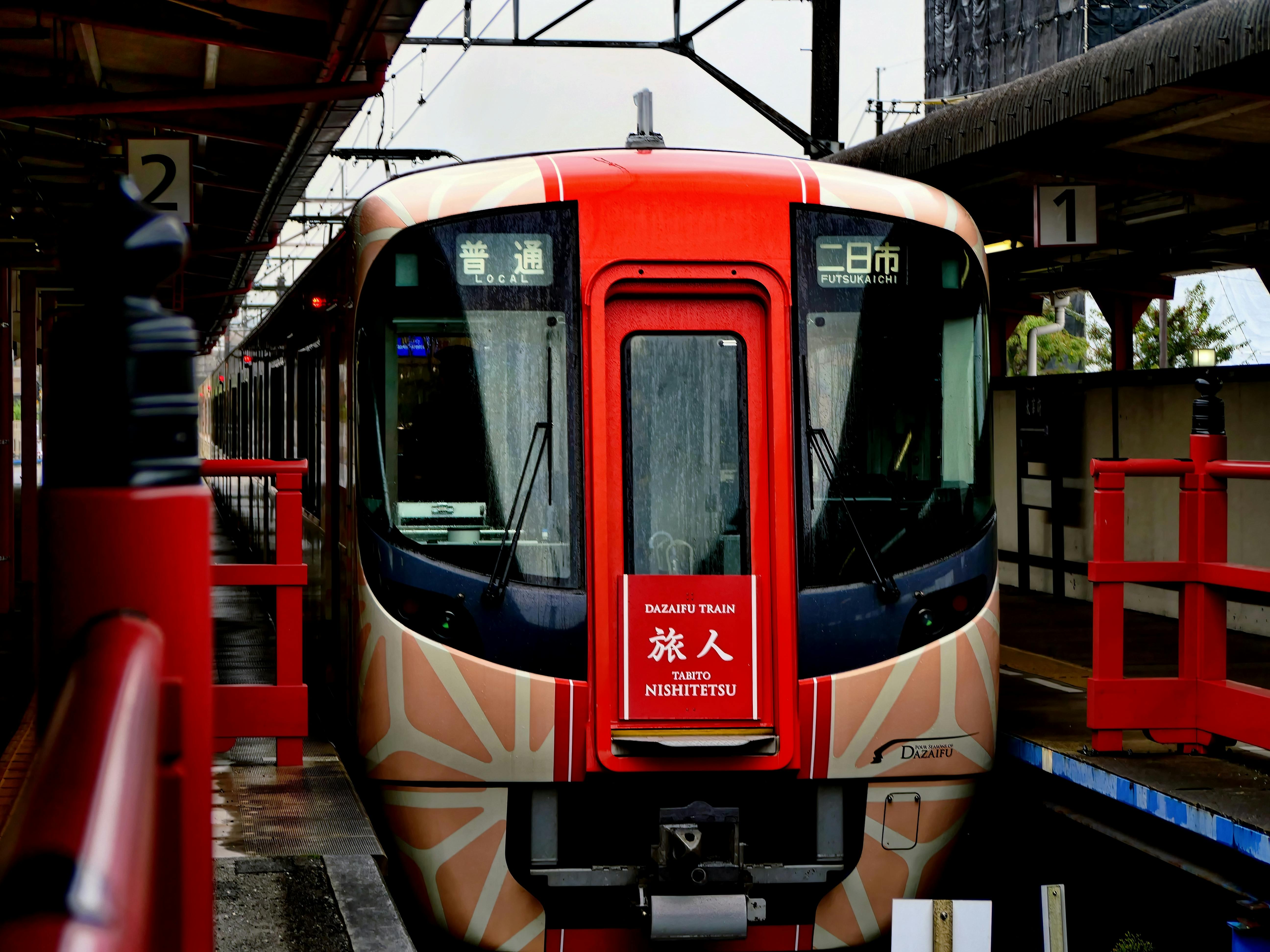 Free Colorful Dazaifu train at Fukuoka terminal, showcasing Japanese public transit. Stock Photo