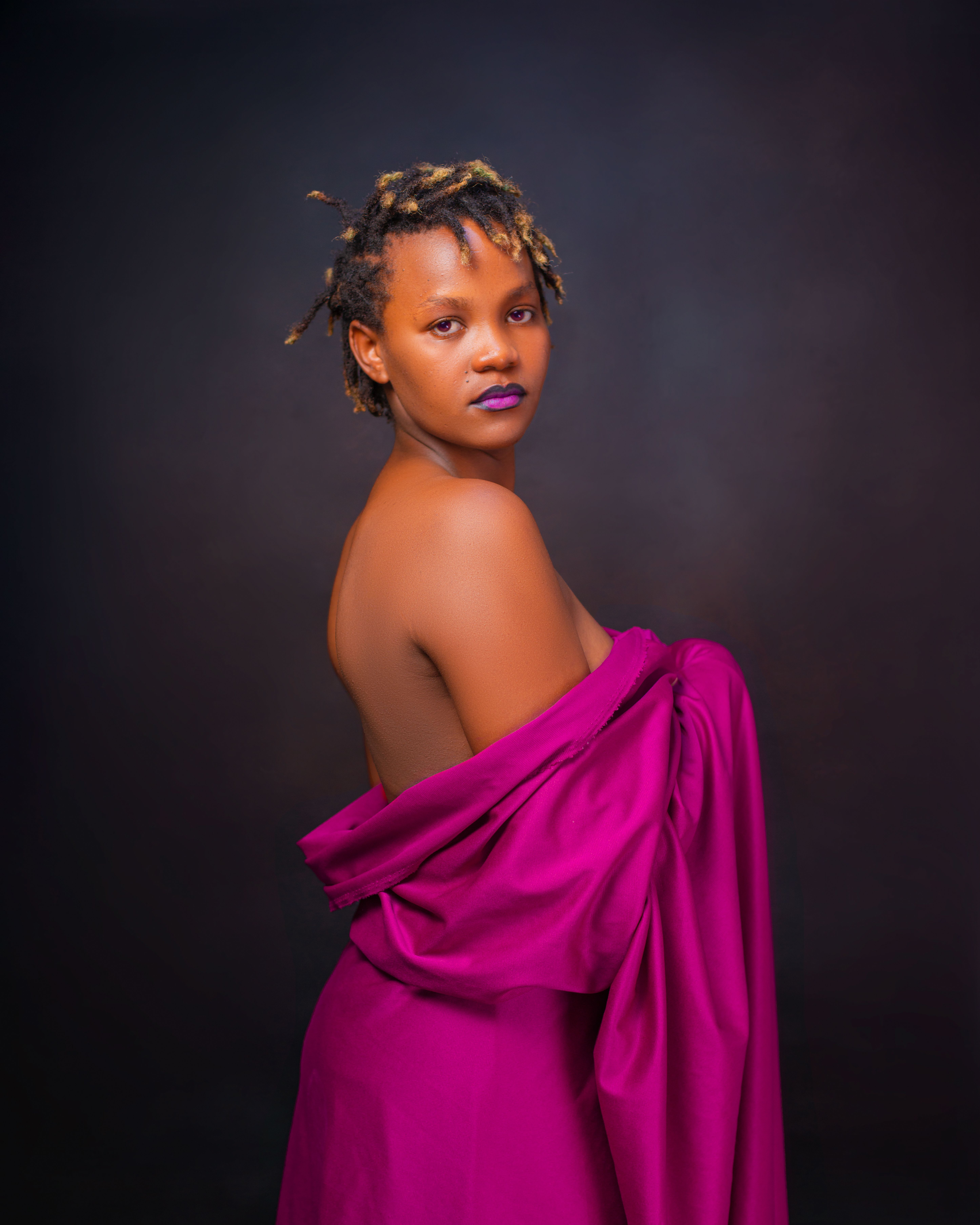 Elegant Portrait of a Woman in Purple Fabric · Free Stock Photo