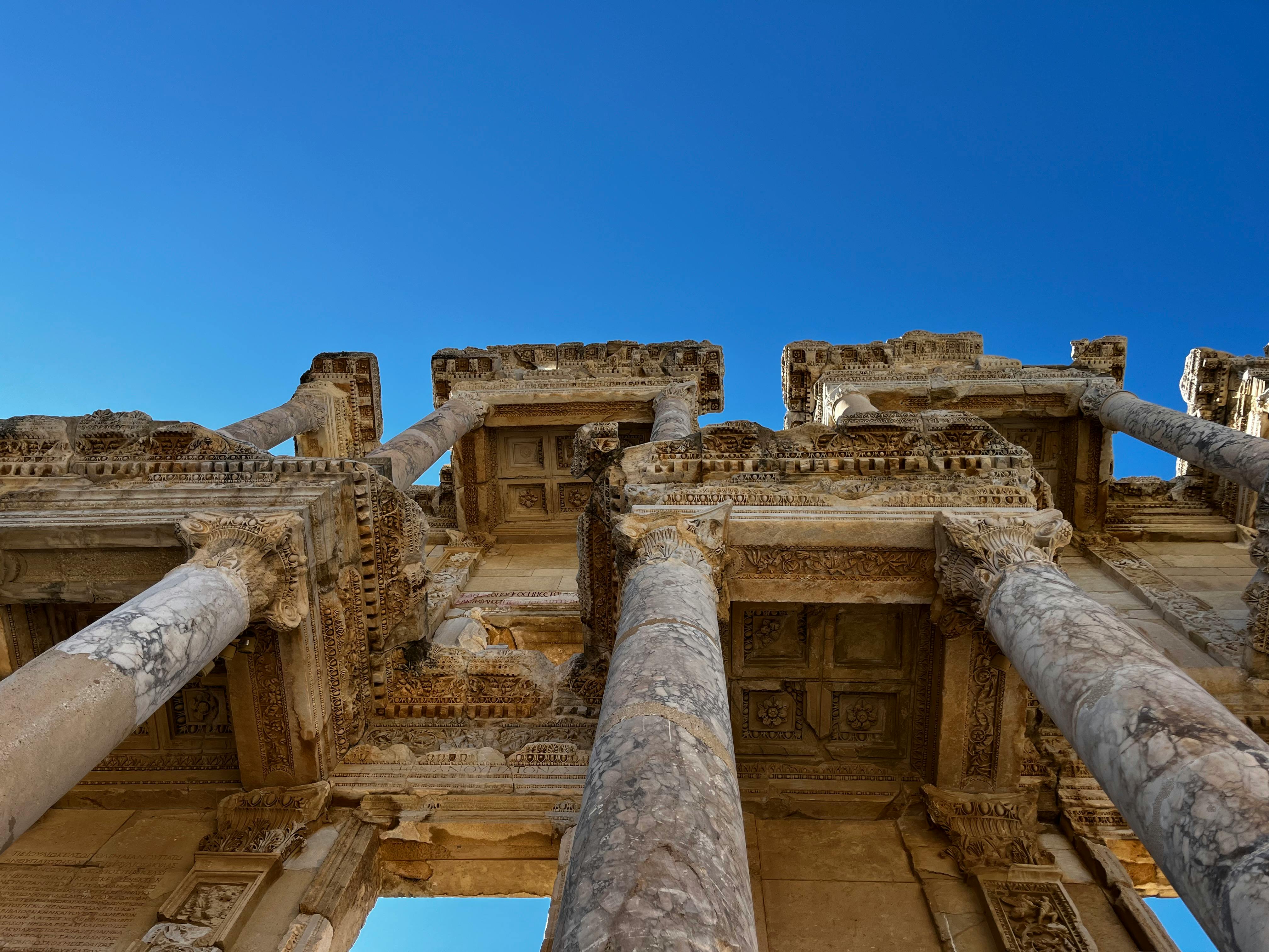 Beautiful view of the ancient Ephesus ruins with a clear blue sky, showcasing detailed architectural columns.