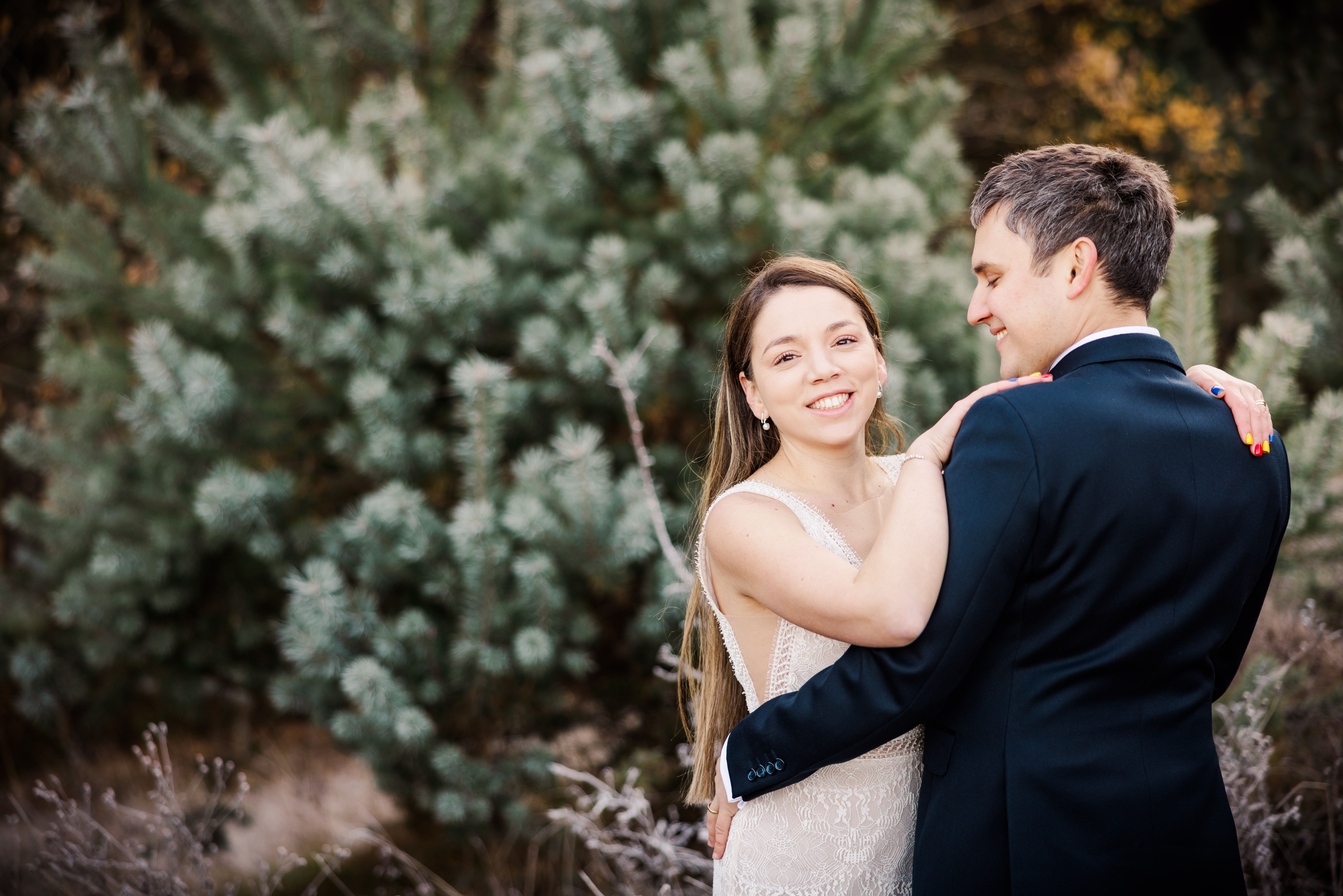 Romantic Wedding Couple Embracing Outdoors · Free Stock Photo