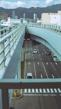 A view of a modern overpass with traffic in Kobe, Japan on a clear day.
