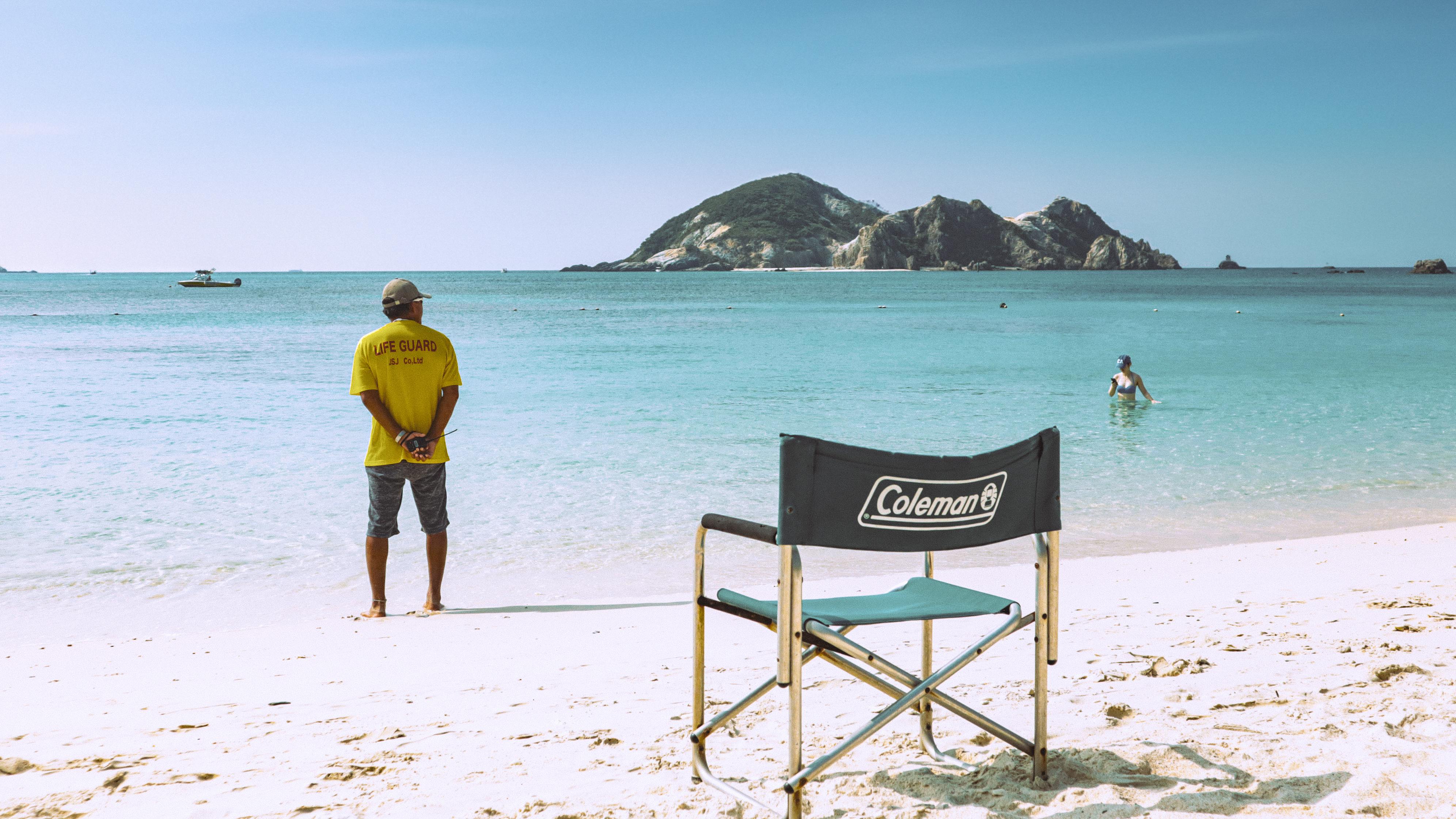 Tranquil beach view with lifeguard and turquoise waters in Tokashiki, Okinawa.