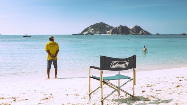 Tranquil beach view with lifeguard and turquoise waters in Tokashiki, Okinawa.