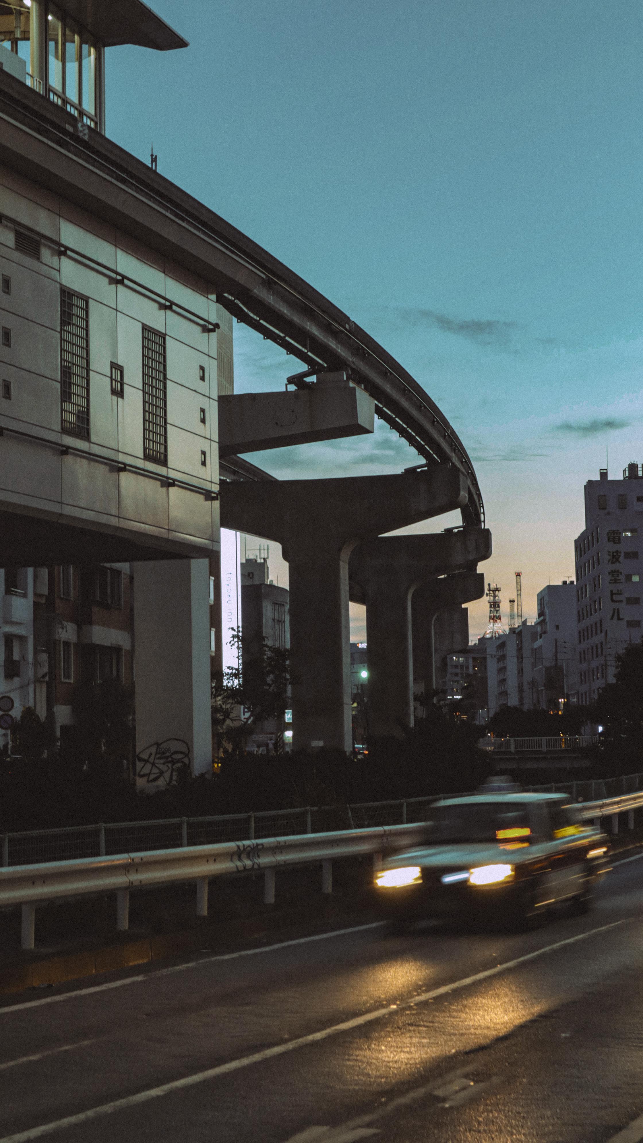A serene evening view of the Naha City monorail system in Okinawa, Japan, captured at twilight.