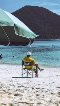 Lifeguard watching over Tokashiki Beach in Okinawa, Japan. Perfect clear skies and turquoise waters create a serene scene.