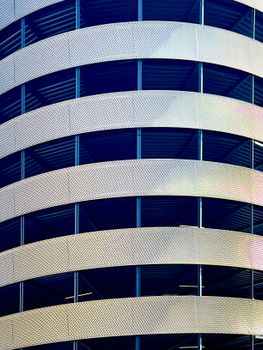 Close-up view of a modern building's spiral design with metal and glass elements.