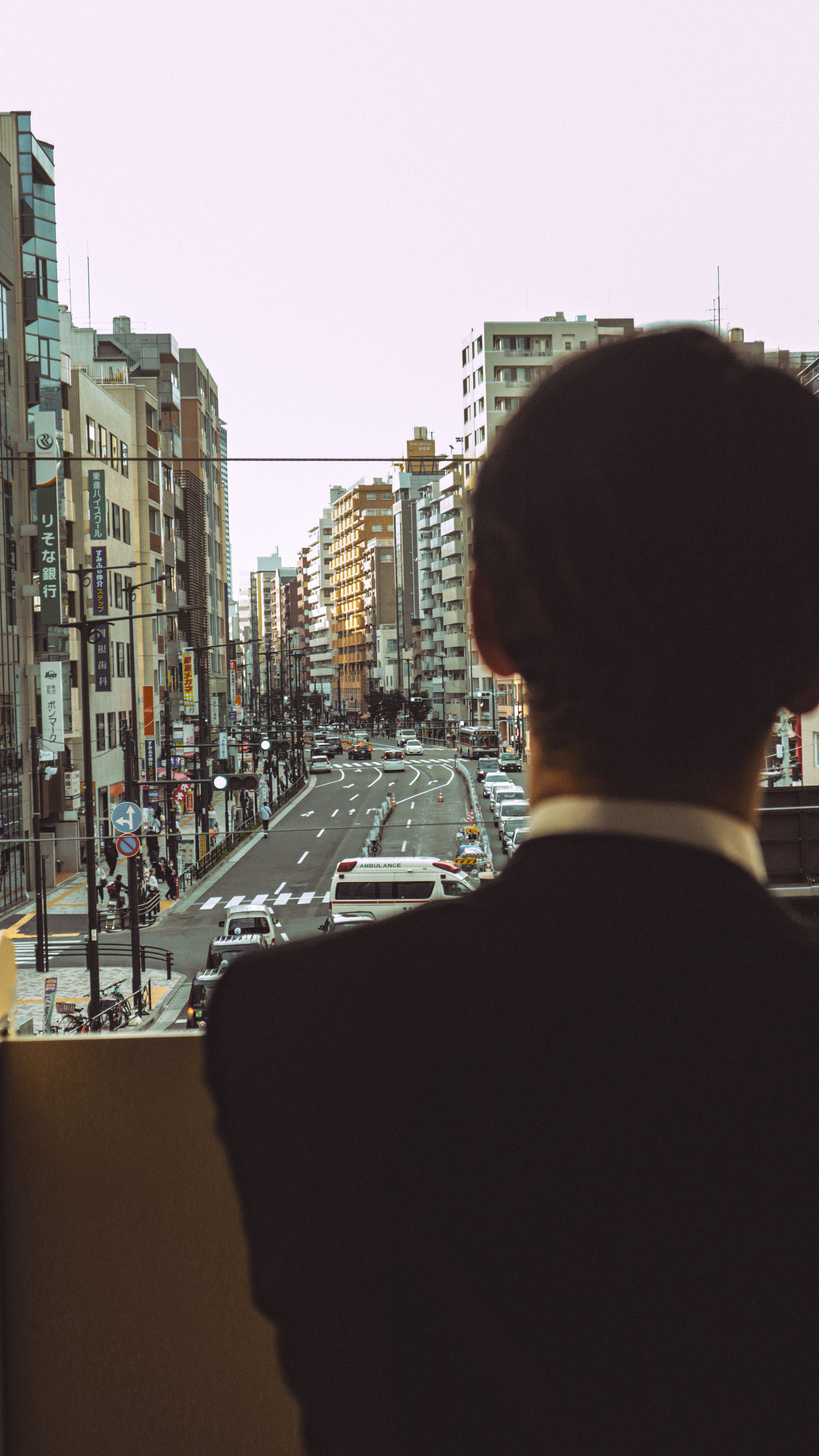 Businessman overlooking Tokyo photographed by João Mira on Pexels