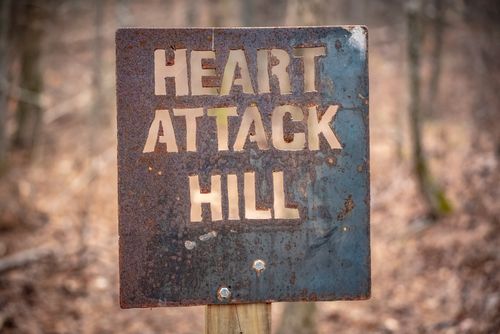 Free Rustic metal sign marking the challenging 'Heart Attack Hill' trail in Winder, Georgia forest. Stock Photo