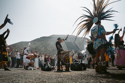Colorful cultural ceremony at the Pyramid of the Sun, Teotihuacán, showcasing vibrant Aztec costumes.