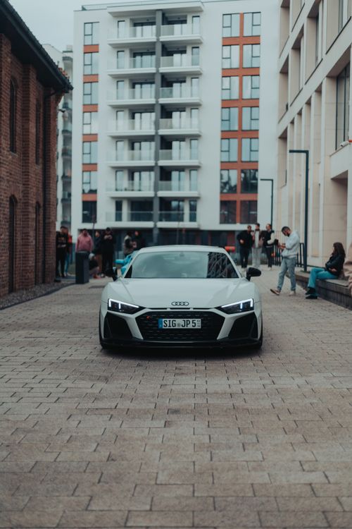 Free A sleek Audi parked on a street in Cluj-Napoca, showcasing modern urban architecture and lifestyle. Stock Photo