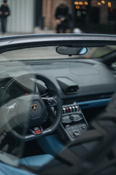Close-up of a luxury Lamborghini car interior, showcasing sleek design and advanced dashboard controls.