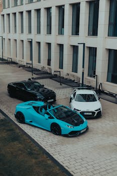 A group of luxury sports cars parked in an urban setting in Cluj-Napoca, Romania.