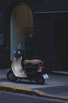 A lone scooter parked on a dimly lit street in Buenos Aires.