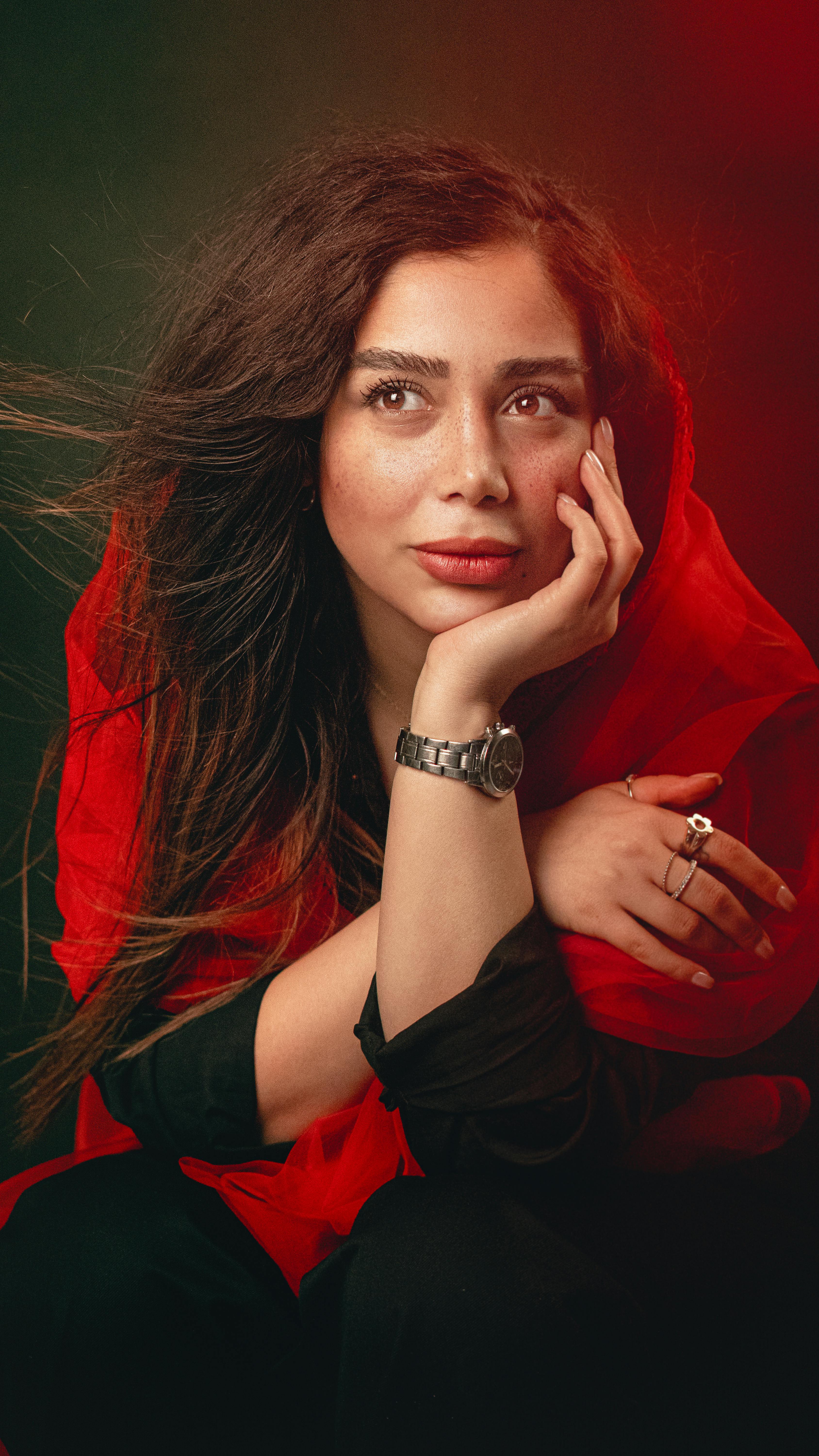 Captivating portrait of a woman in a red shawl, Hamedan, Iran.