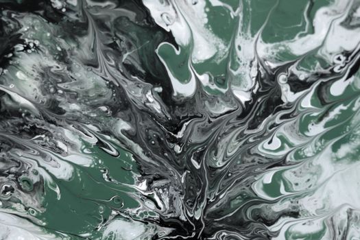 Fluid art featuring intricate green and black swirls creating a mesmerizing abstract pattern.