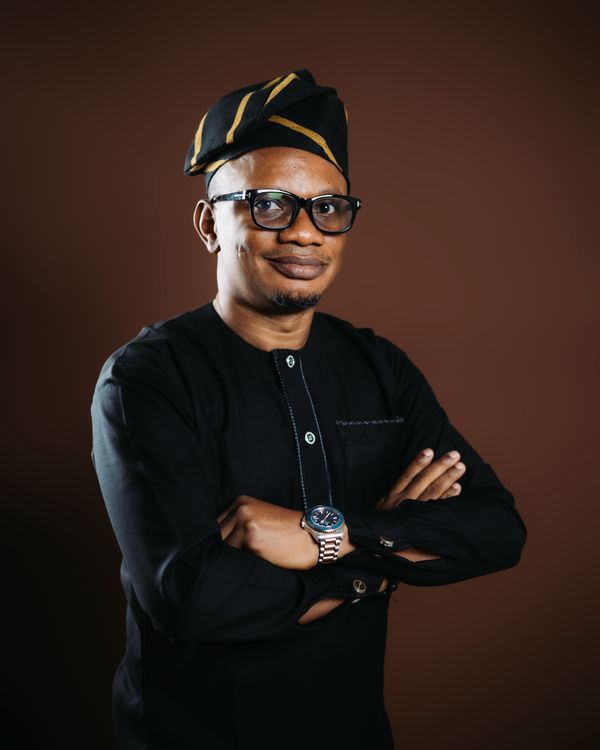Nigerian man smiling in a traditional hat