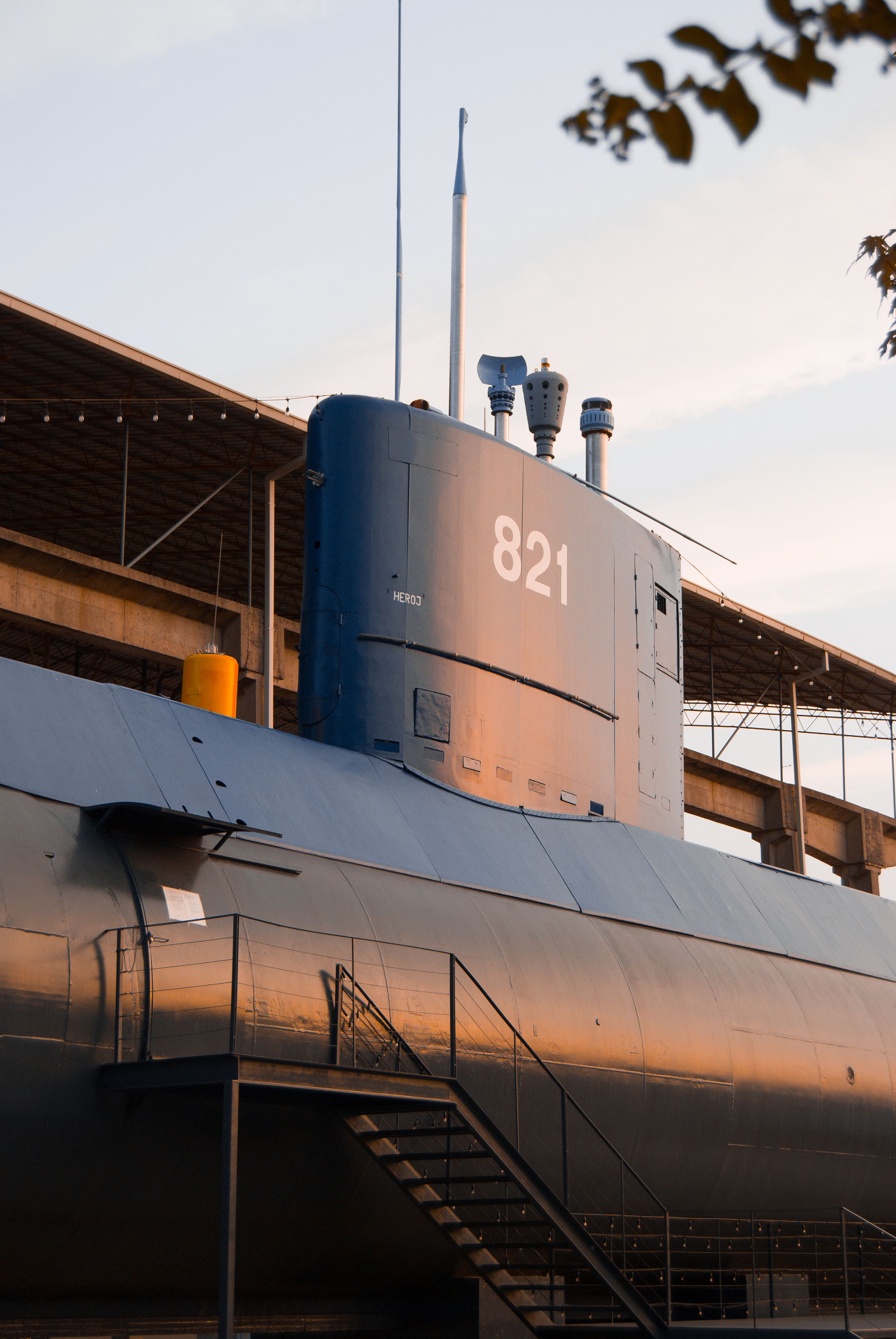 Submarine 821 displayed outdoors with a warm sunset glow, showcasing naval history.