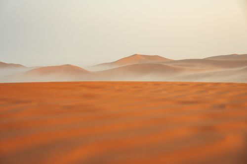 Free Peaceful view of sand dunes and mist at sunrise, highlighting desert serenity. Stock Photo