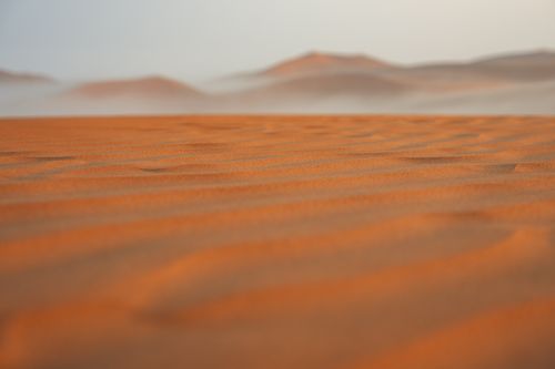 Free Peaceful sand dunes stretch into the distance, capturing the essence of serenity in the desert at dusk. Stock Photo