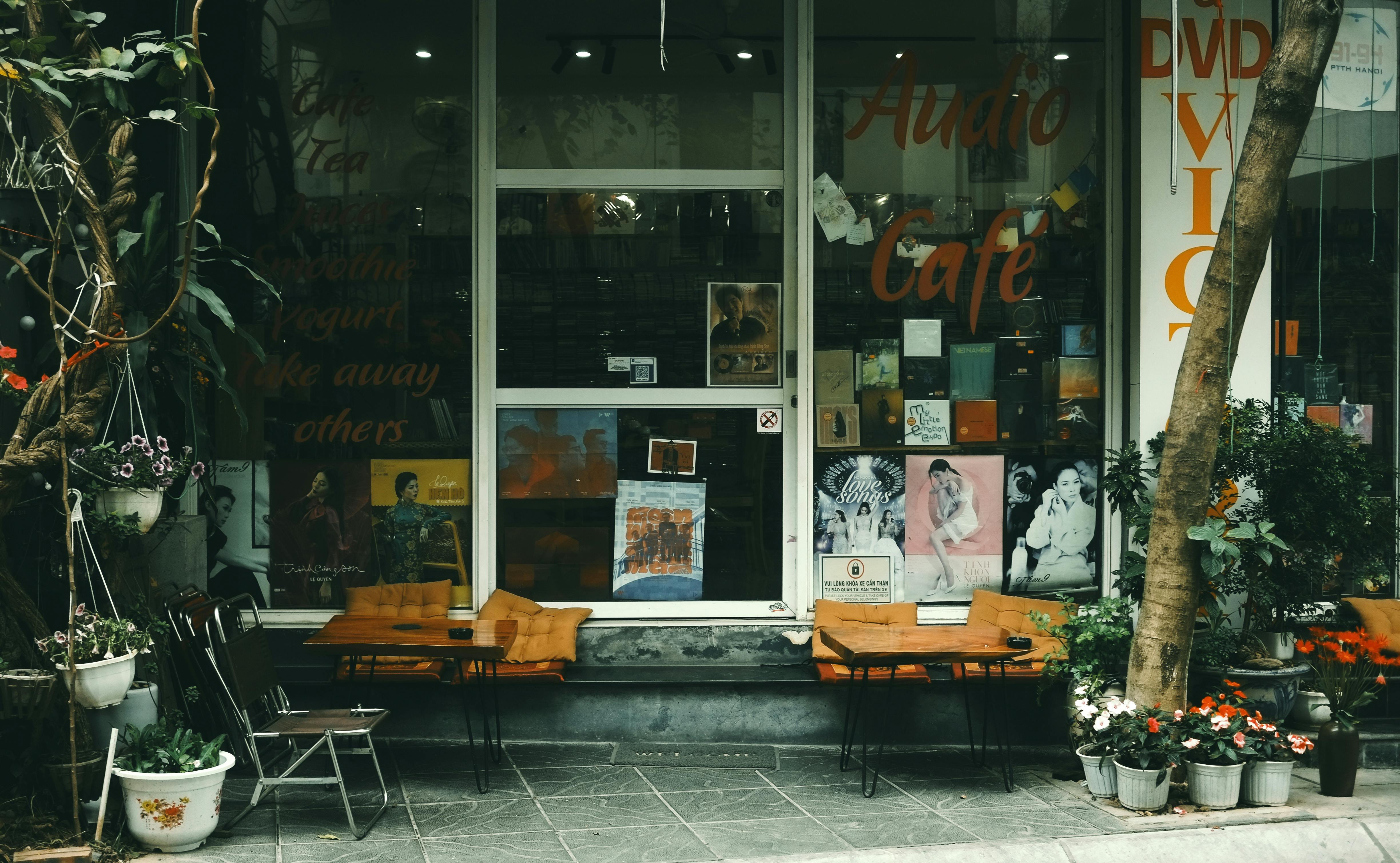 Cozy vintage cafe in Hanoi, Vietnam, with outdoor seating and vibrant decor.