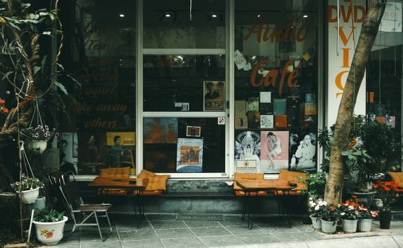 Cozy vintage cafe in Hanoi, Vietnam, with outdoor seating and vibrant decor.