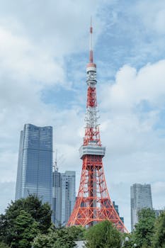 Tokyo Tower stands tall against the modern skyline of Minato City, Tokyo.