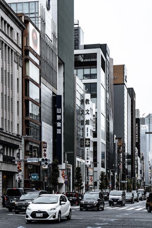 Free Chūō, Tokyo street view with modern buildings and traffic, capturing urban life in Japan. Stock Photo