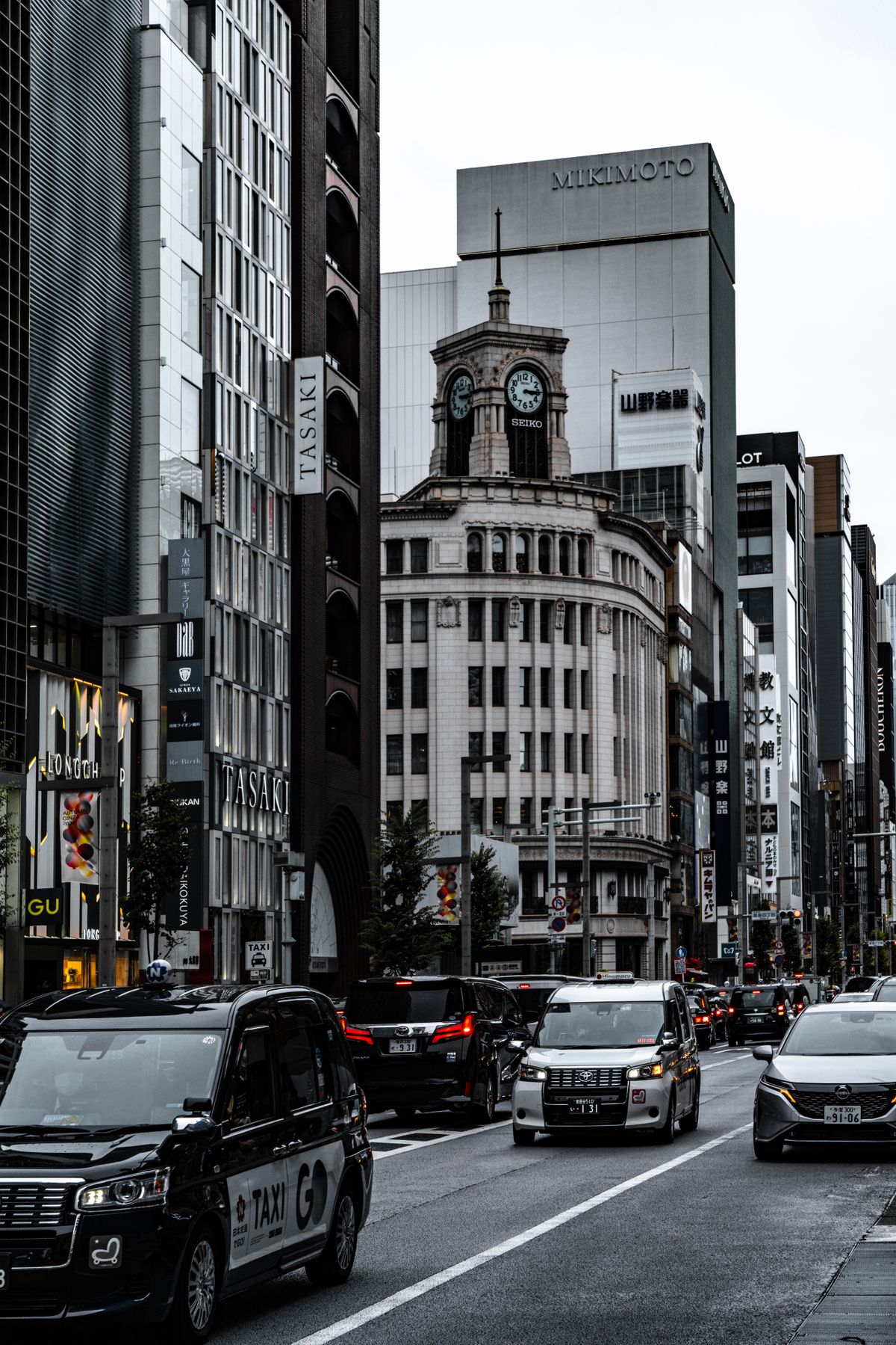 Bustling main street in the Ginza district of Tokyo lined with luxury shops and elegant buildings