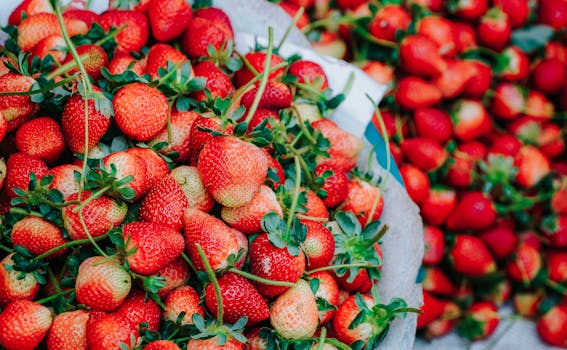 Close-up of fresh, ripe strawberries in a market setting showcasing vibrant red colors.
