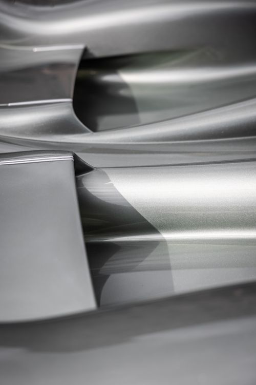 Free Intricate close-up of metallic car details showcasing sleek curves and reflections. Stock Photo