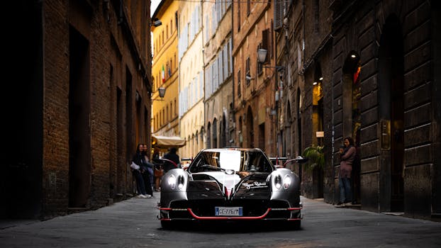 A sleek sports car parked in a historic Italian alleyway, conveying luxury and style.