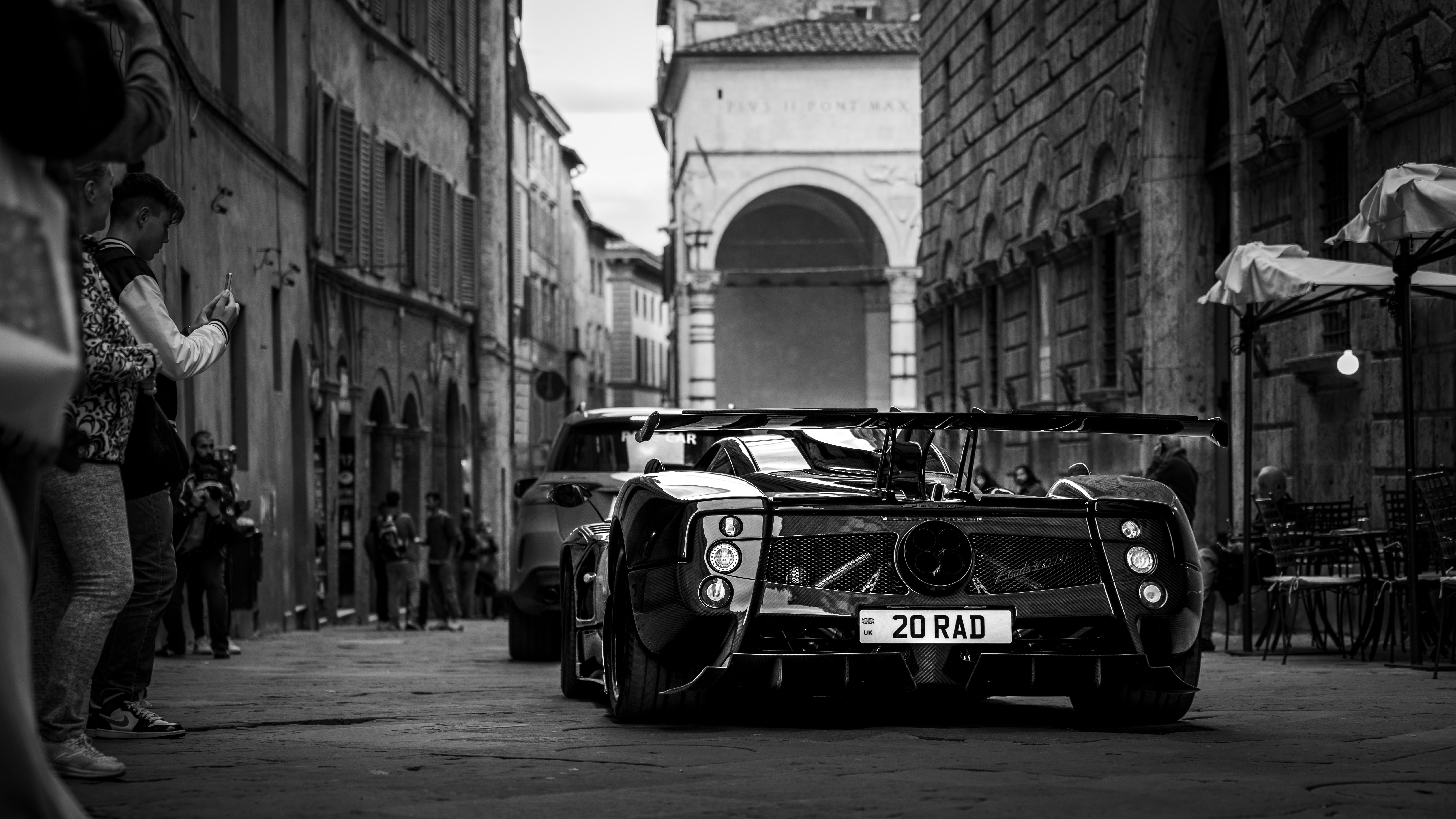 Black luxury sports car shown from the rear three-quarter angle