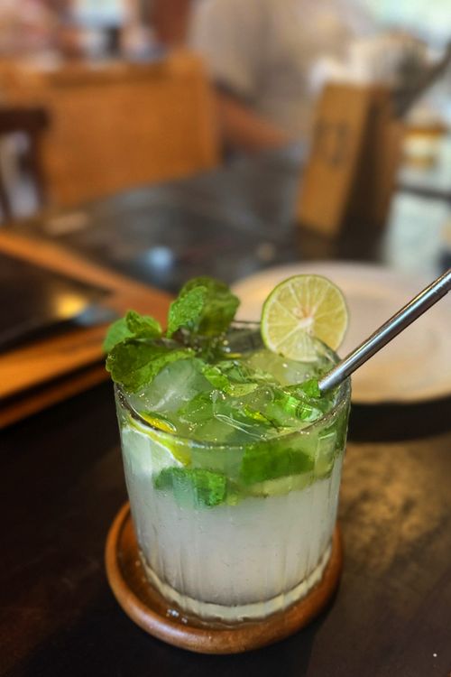 Free Close-up of a refreshing mojito cocktail with mint and lime on a wooden table. Stock Photo