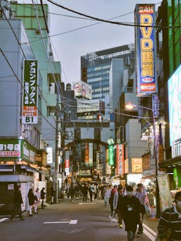 Lively street with neon signs in Tokyo, capturing urban life and vibrant culture.