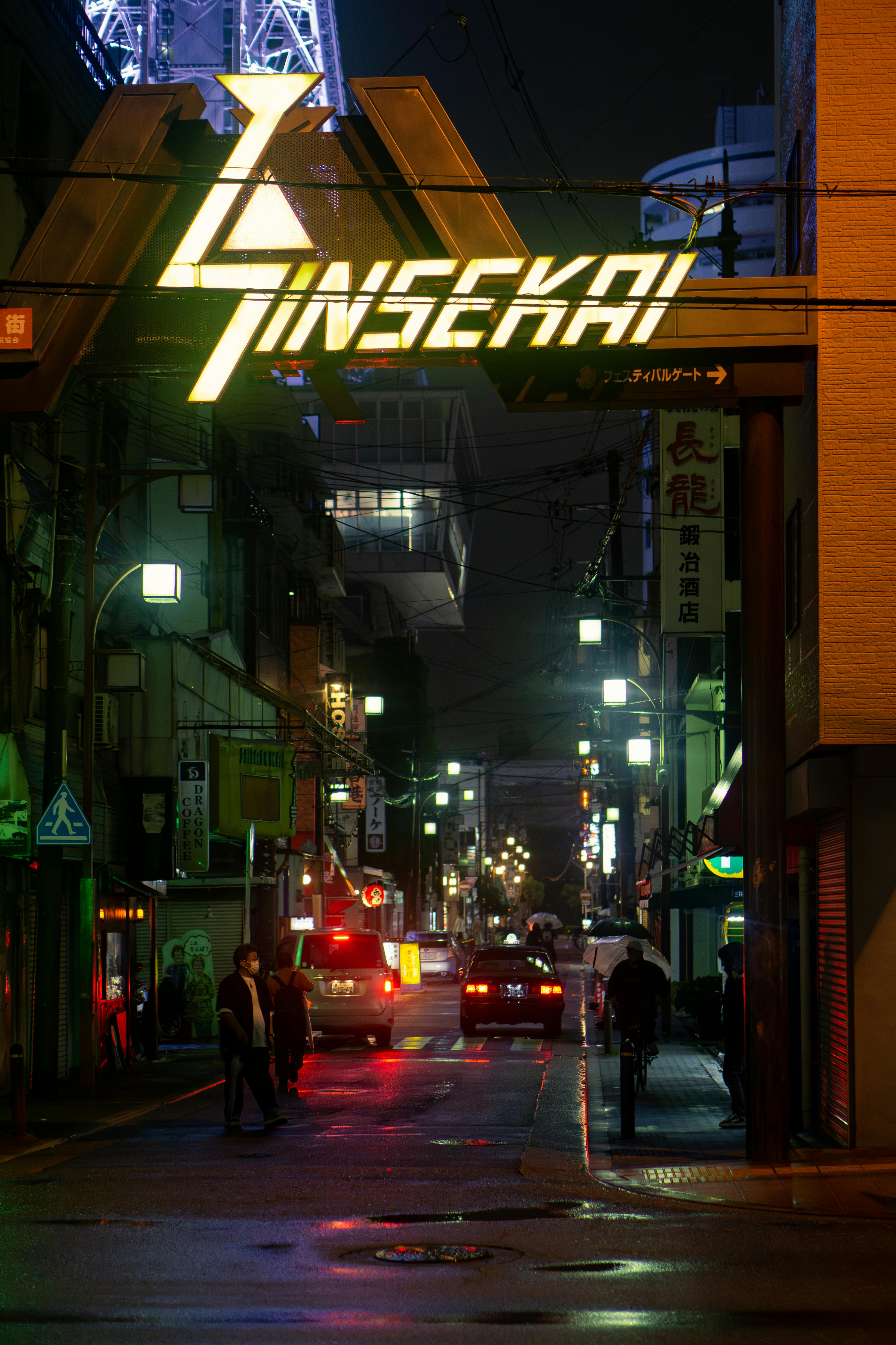 Neon-lit Osaka street at night showcasing Shinsekai's vibrant urban life.