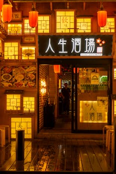 Illuminated Asian restaurant entrance with traditional decor and warm lighting at night.